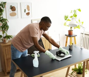 high-angle-man-cleaning-table